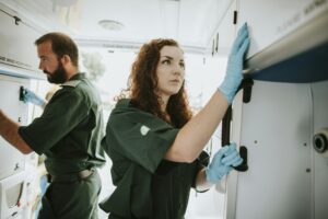 Paramedic team checking equipment in an ambulance