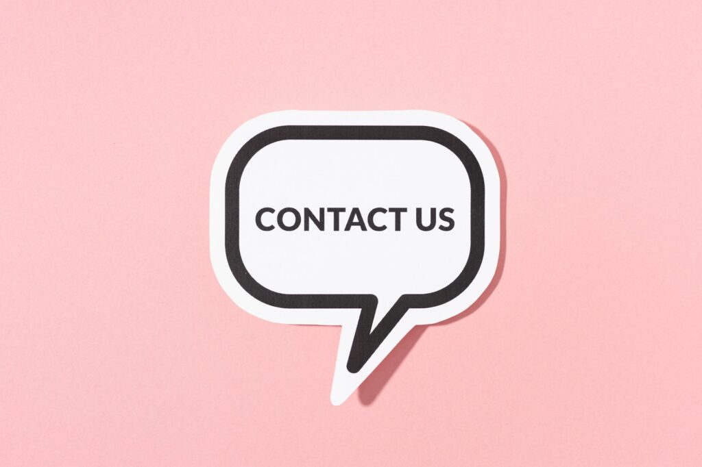 Contact Us text on speech bubble isolated on pink background