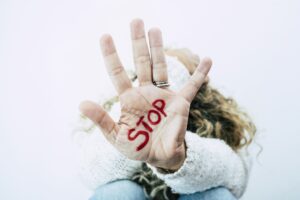 Women's day concept and stop abuse violence on females people - closeup of hand with stop